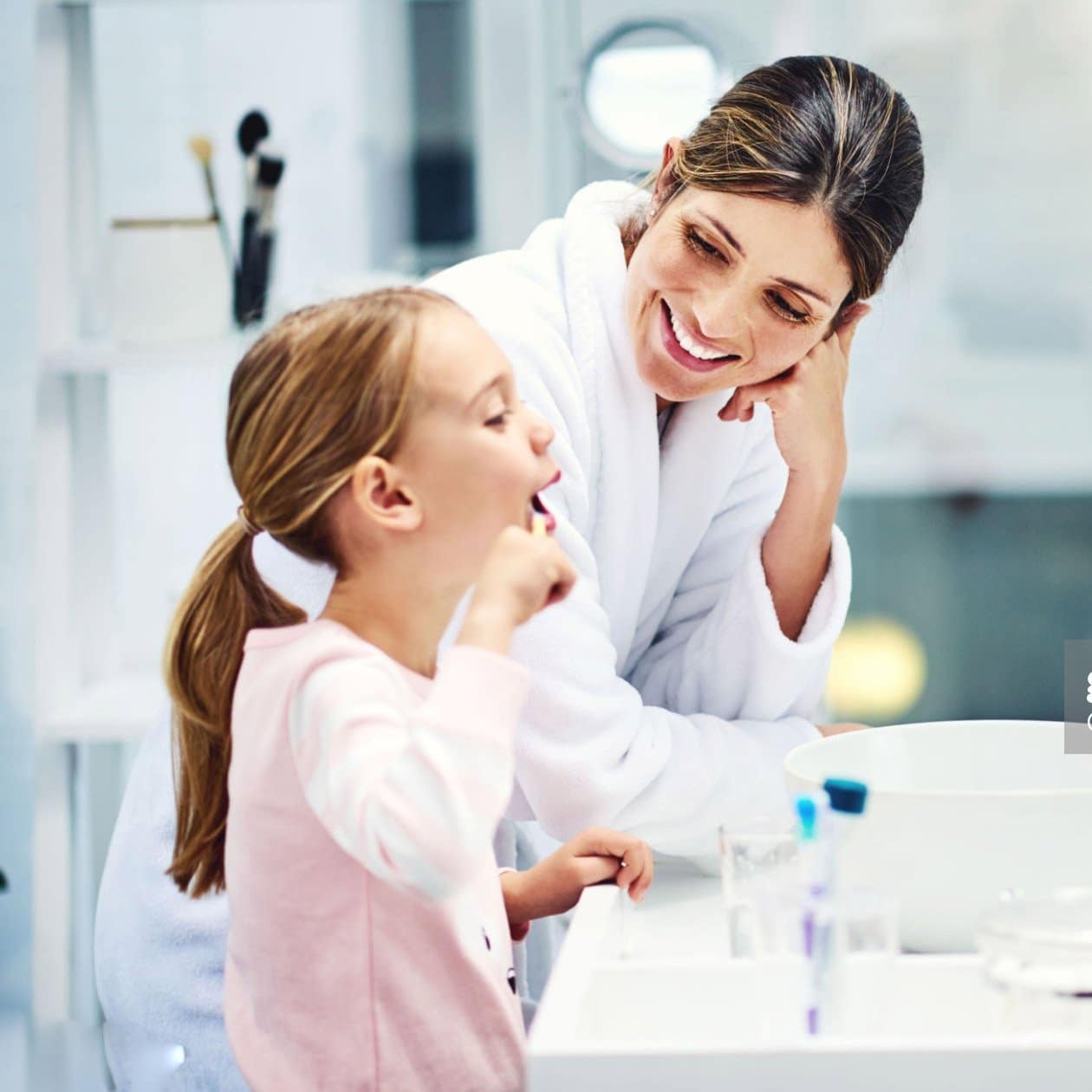 Мама с дочкой чистят зубы